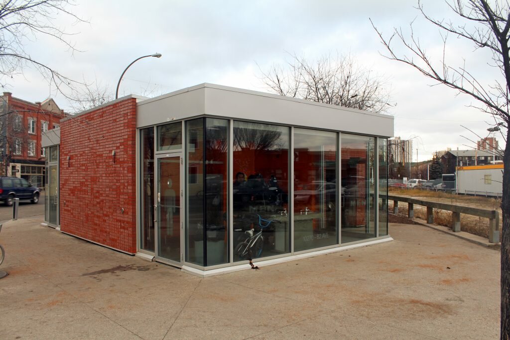 A group of men stand inside a public washroom in Edmonton's Whyte Avenue. Edmonton councillor, Scott McKeens says he's looking to build more washrooms like these around Edmonton. (Photo credit to Connor MacDonald)